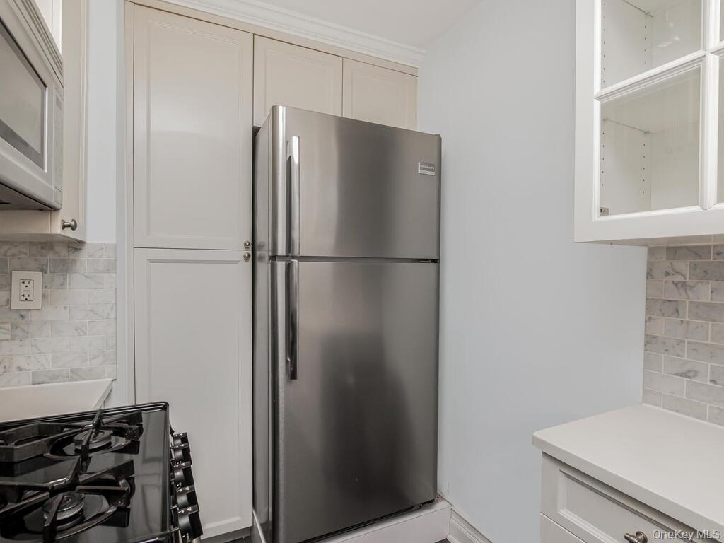 1332 Midland Avenue, Unit 3F Bronxville, NY 10708 - Photo 10 of 21 a white refrigerator freezer and a stove sitting inside of a kitchen