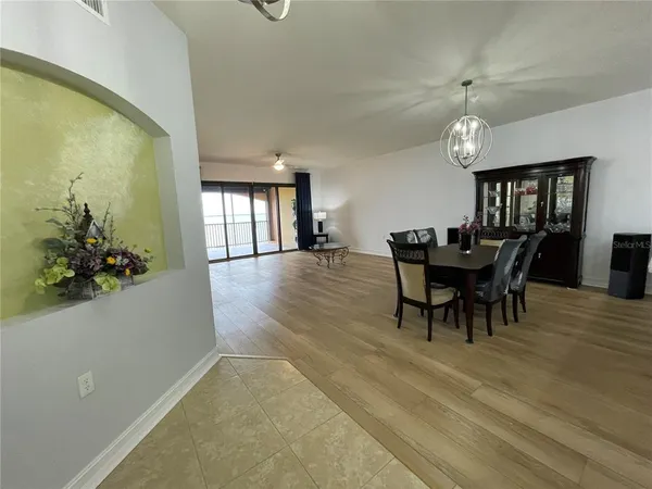 a view of a dining room with furniture and chandelier