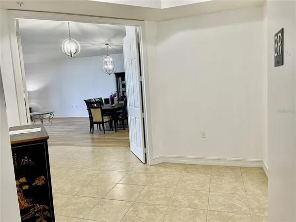 a living room with furniture a flat screen tv and a large window
