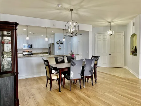 a kitchen with stainless steel appliances granite countertop a stove a refrigerator a sink a microwave and island