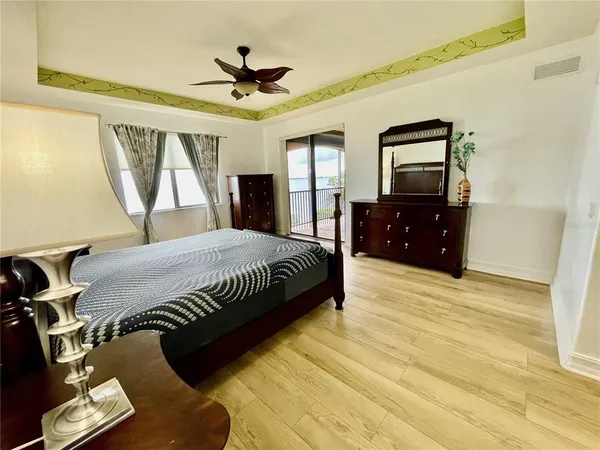 a front view of a house with swimming pool and chairs