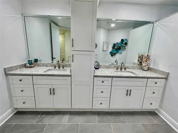 a view of a patio with a table and chairs under an umbrella