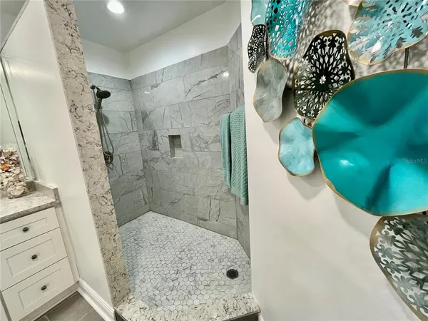 a palm tree sitting in front of a with a yard