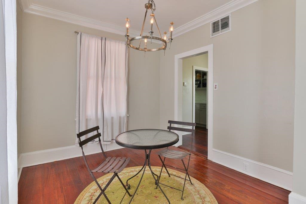 40 Abbott Street St. Augustine, FL 32084 - Photo 16 of 58 Dining area featuring a chandelier, wood finished floors, and crown molding
