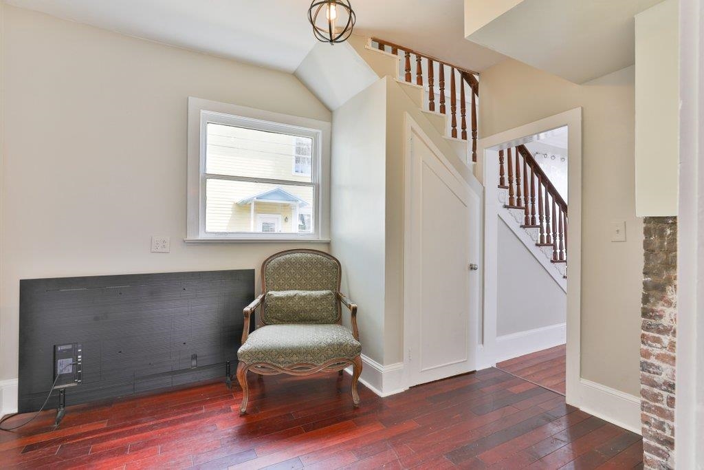40 Abbott Street St. Augustine, FL 32084 - Photo 20 of 58 Living area with stairway and dark wood-style flooring