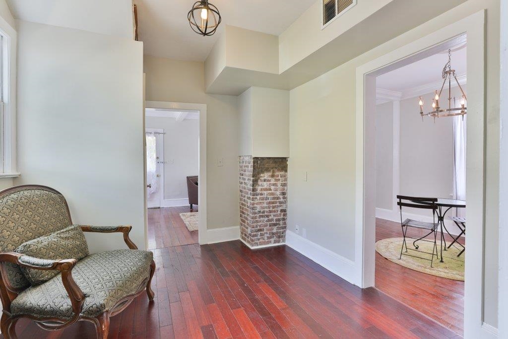 40 Abbott Street St. Augustine, FL 32084 - Photo 21 of 58 Sitting room featuring dark wood-type flooring and a chandelier