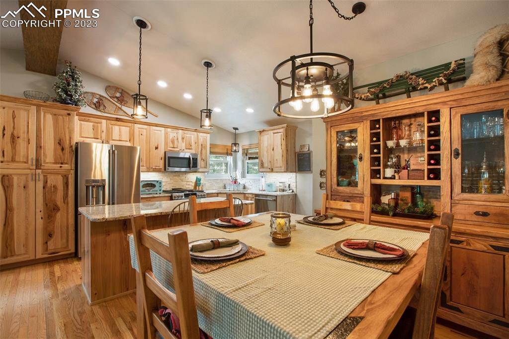 290 North Mountain Estates Road Florissant, CO 80816 - Photo 18 of 32 a kitchen with stainless steel appliances granite countertop a sink a refrigerator and a stove