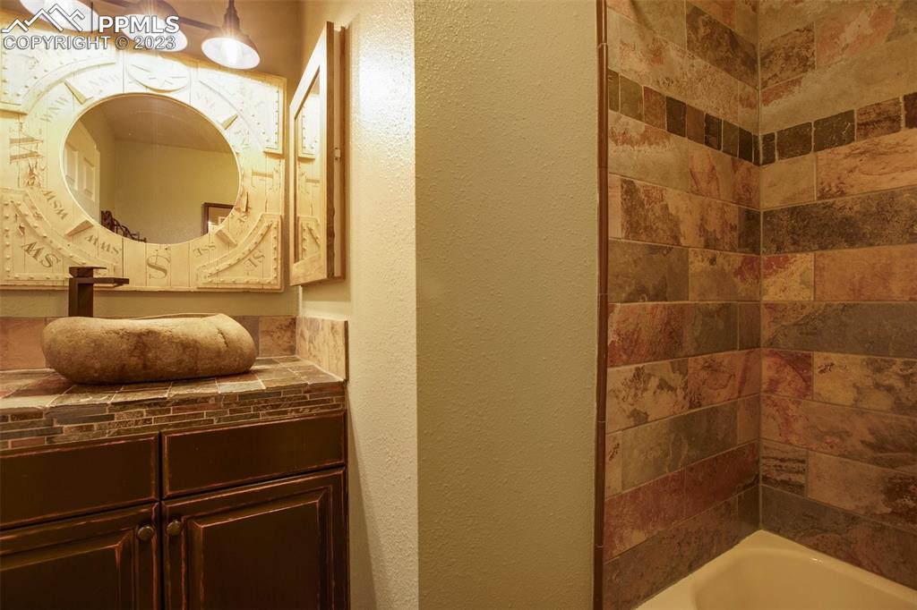 290 North Mountain Estates Road Florissant, CO 80816 - Photo 30 of 32 a bathroom with a sink and a mirror