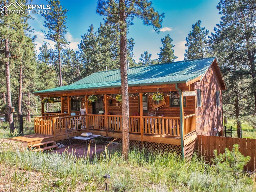 290 North Mountain Estates Road Florissant, CO 80816 - Photo 3 of 32 a view of a house with a yard and sitting area