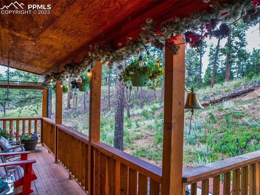 290 North Mountain Estates Road Florissant, CO 80816 - Photo 9 of 32 a view of a porch with furniture and wooden deck