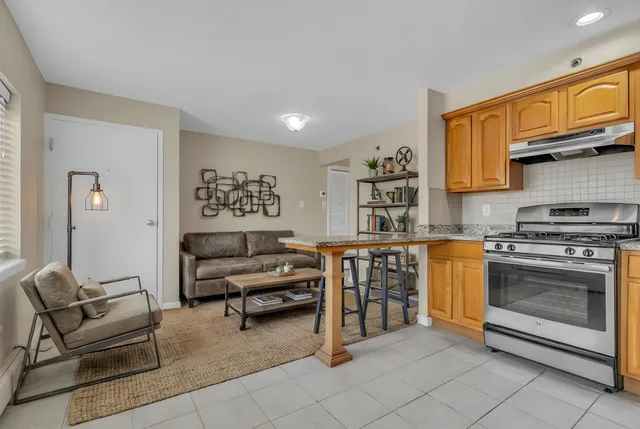 a living room with furniture and kitchen view