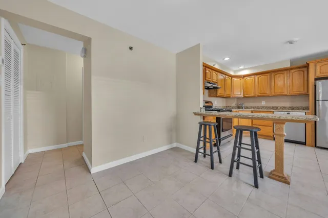 a view of kitchen with stainless steel appliances granite countertop cabinets and a counter top space