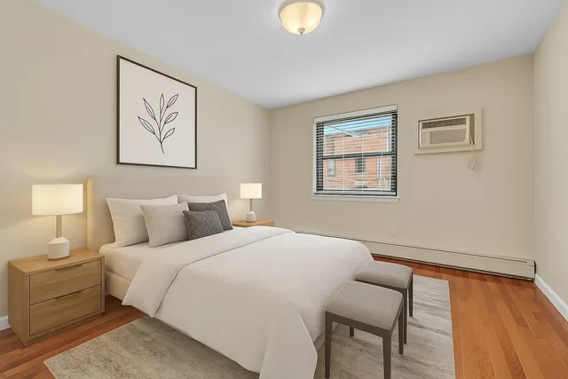 a bedroom with a bed and a window