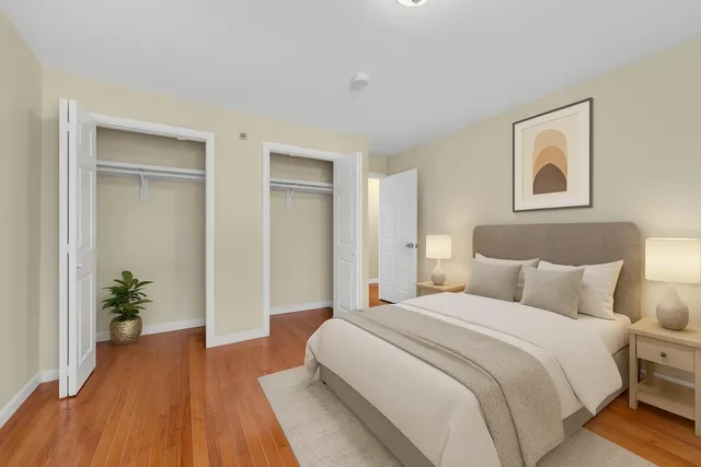 a bedroom with a bed and a potted plant