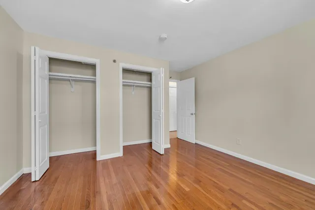 a view of an empty room and wooden floor