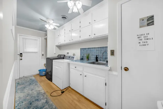 a kitchen with white cabinets and white appliances