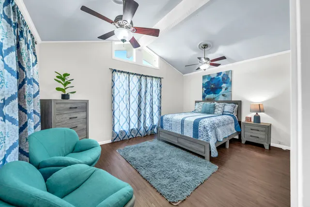 a bedroom with a bed couch and dresser