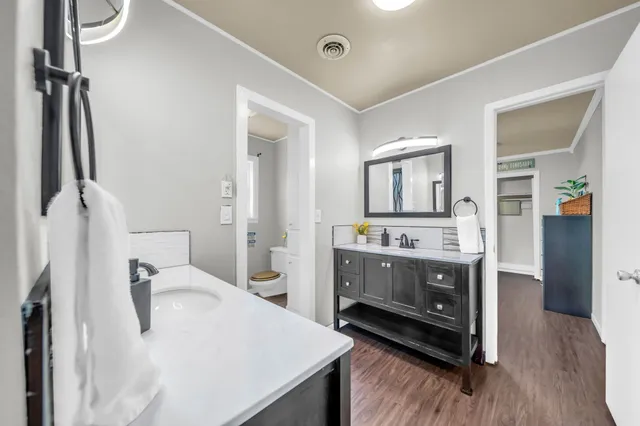 a en suite bathroom with a sink double vanity and a mirror