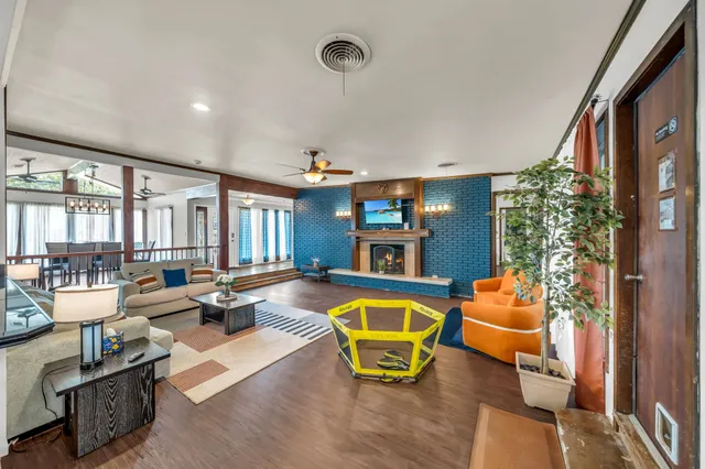 a living room with patio furniture and a large window