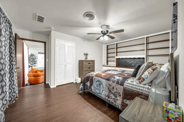 a bedroom with furniture and a chandelier