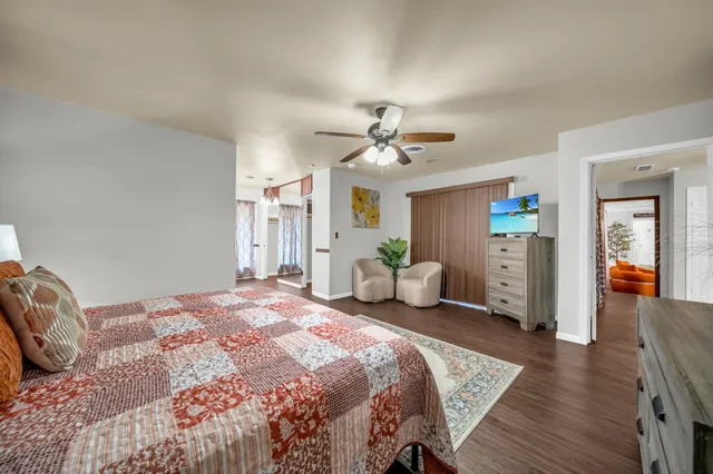 a spacious bedroom with a bed and a chandelier