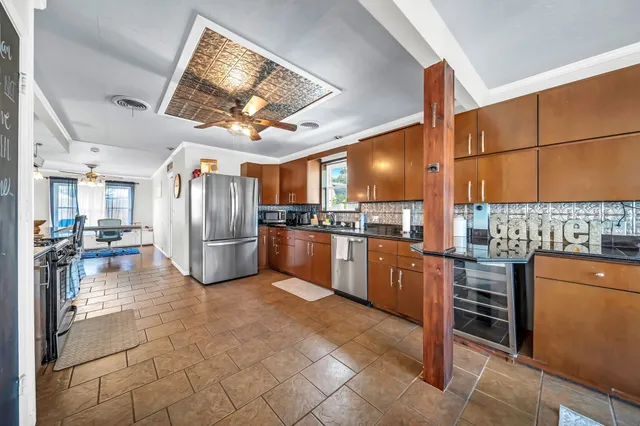 a kitchen with refrigerator and cabinets