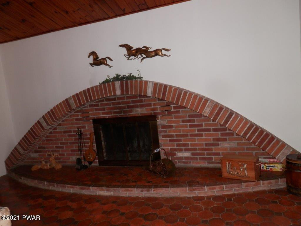 112 Squirrel Road Dingmans Ferry, PA 18328 - Photo 9 of 26 a view of a fireplace with a hallway