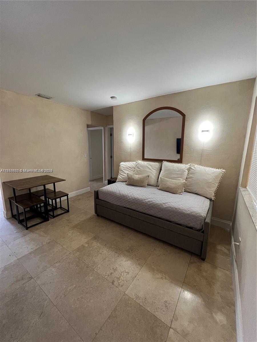 a bedroom with a bed and a couch