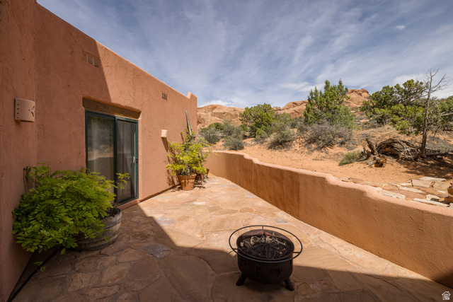 3617 Red Rock Drive Moab, UT 84532 - Photo 10 of 79 View of patio with an outdoor fire pit and a mountain view