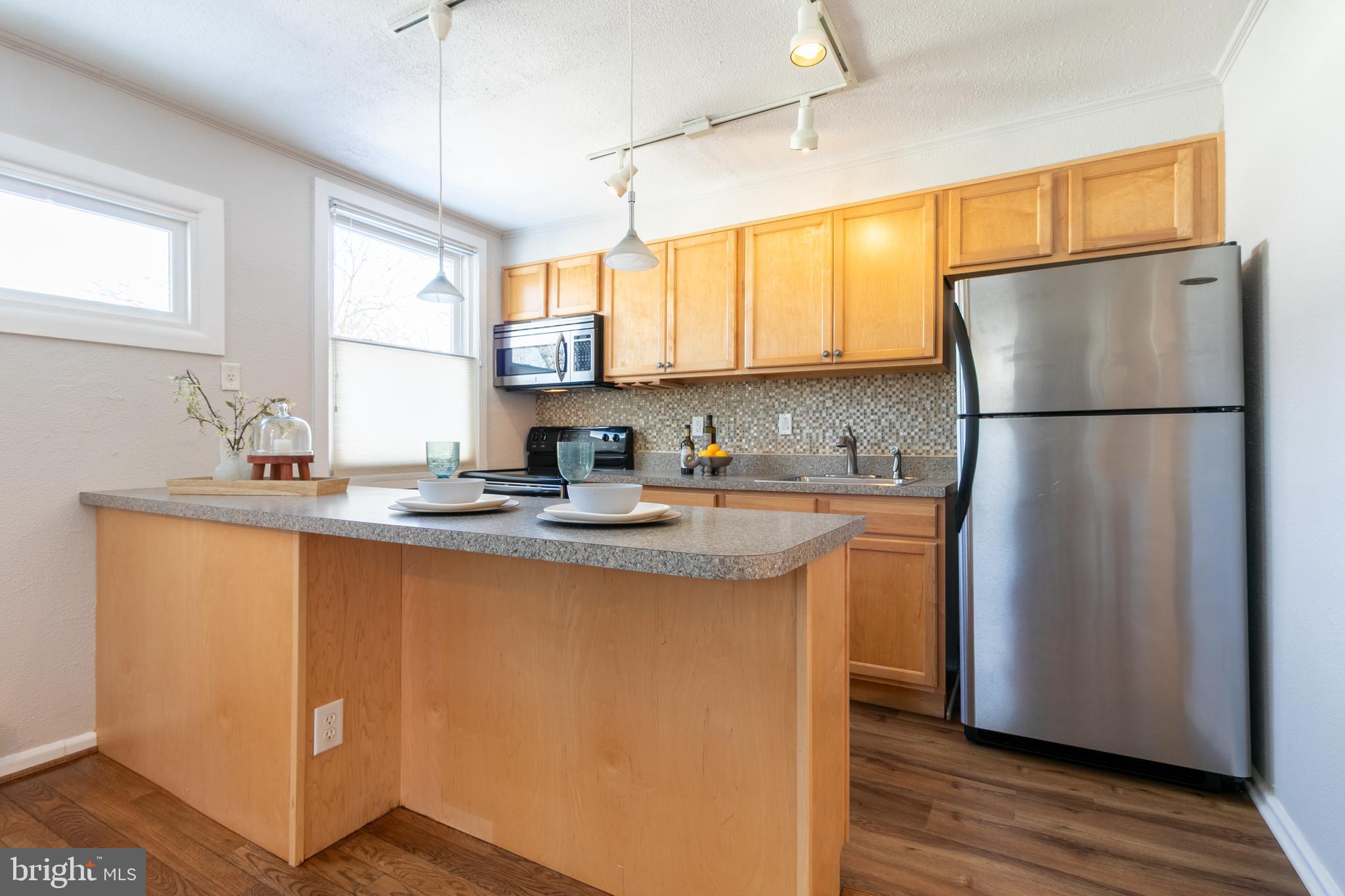 4 Plateau Place Greenbelt, MD 20770 - Photo 11 of 21 a kitchen with stainless steel appliances granite countertop a refrigerator sink and cabinets