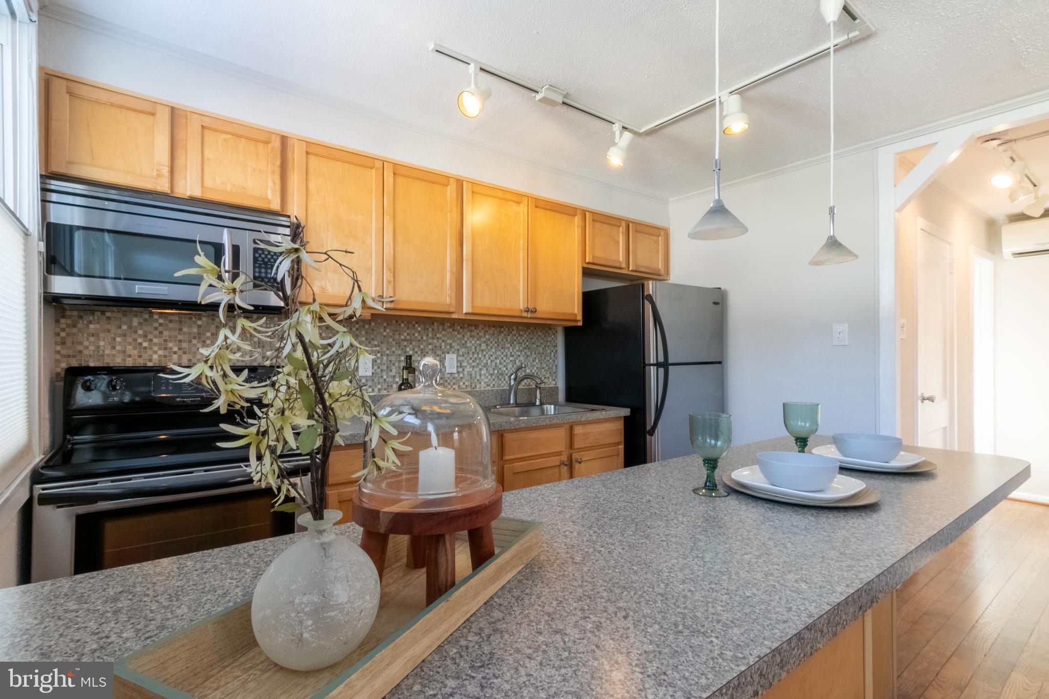 4 Plateau Place Greenbelt, MD 20770 - Photo 12 of 21 a kitchen with stainless steel appliances granite countertop a stove refrigerator and cabinets