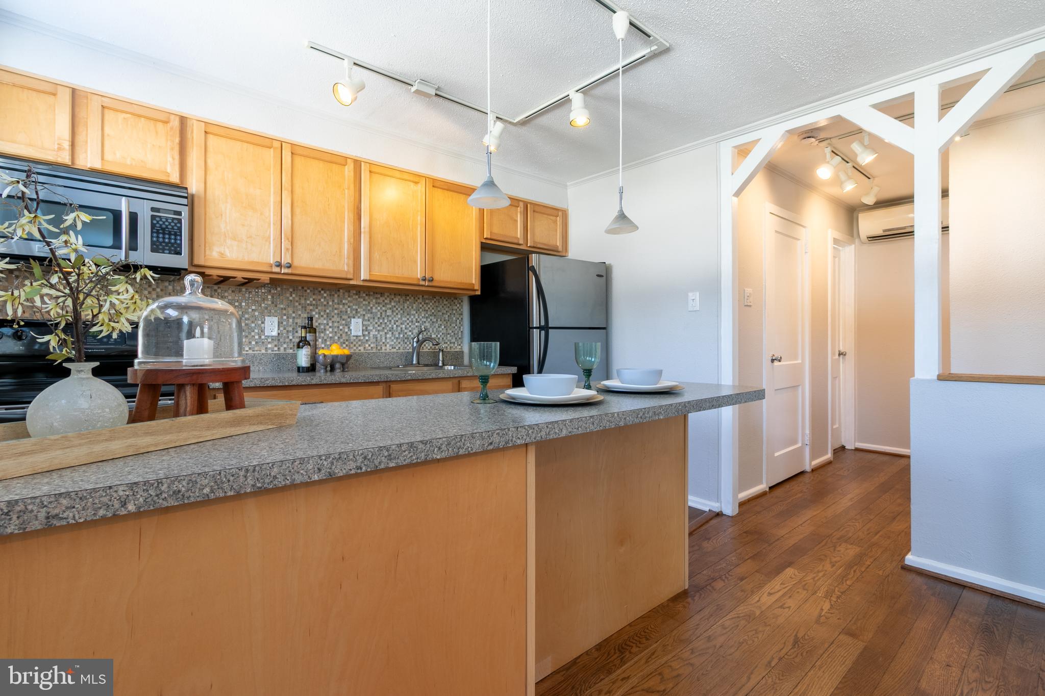 4 Plateau Place Greenbelt, MD 20770 - Photo 13 of 21 a kitchen with stainless steel appliances granite countertop a sink a stove and a refrigerator