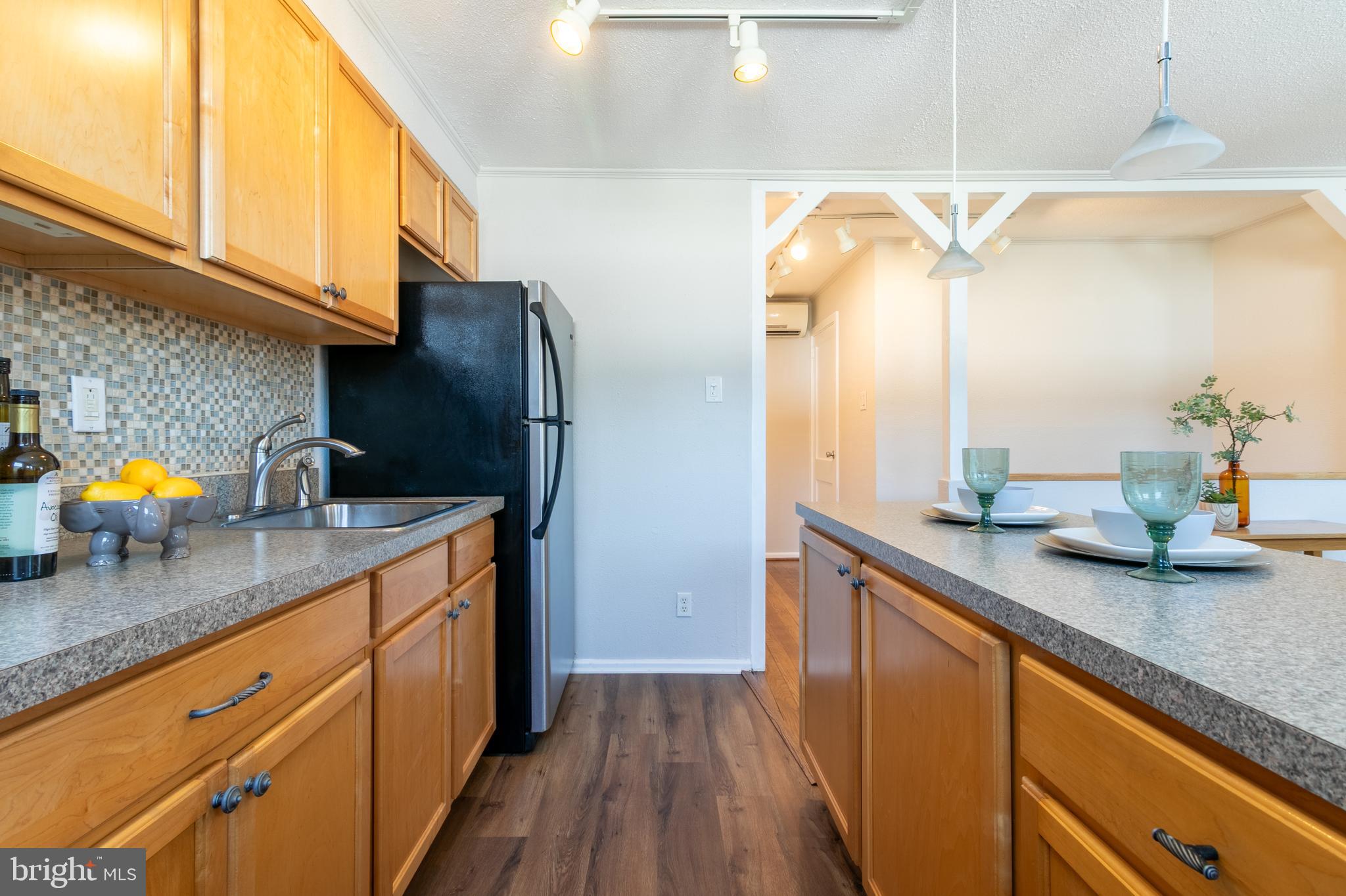 4 Plateau Place Greenbelt, MD 20770 - Photo 14 of 21 a kitchen with stainless steel appliances granite countertop a sink a stove and a wooden floors