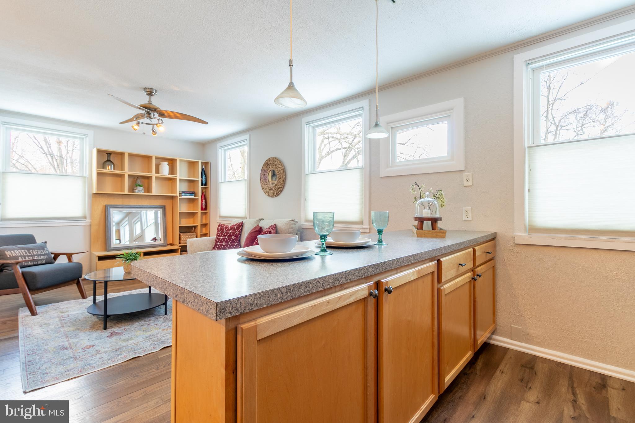 4 Plateau Place Greenbelt, MD 20770 - Photo 10 of 21 a kitchen with sink cabinets and living room view