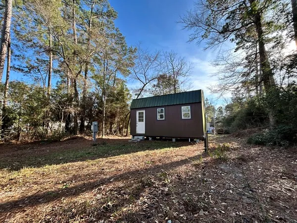 a view of a large tree in front of a house