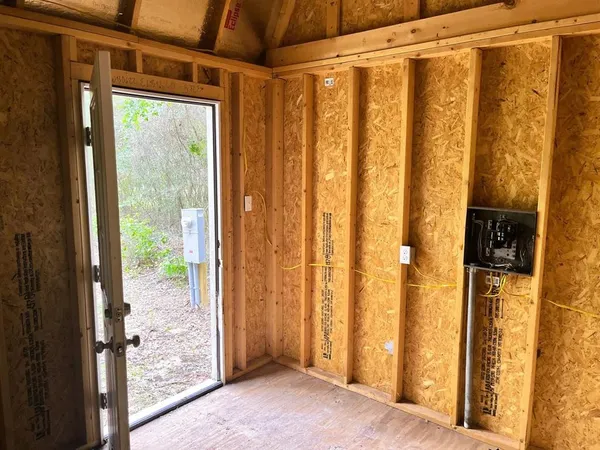 a view of a hallway with wooden floor and entryway