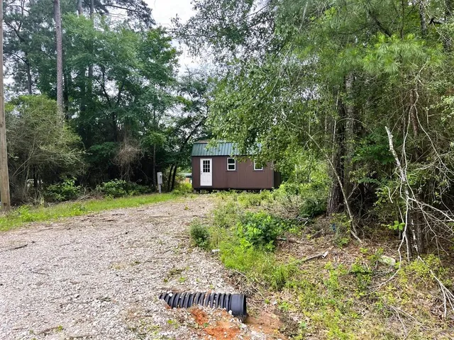 a backyard of a house with yard and trampoline