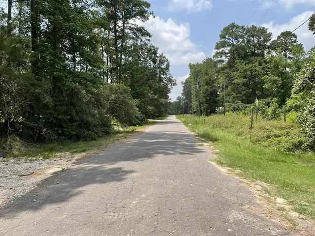 a view of a car garage with a small yard and plants