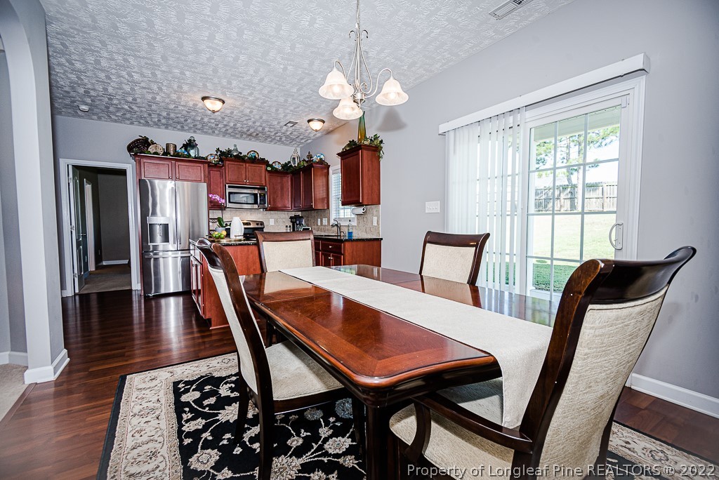63 Colonist Place Cameron, NC 28326 - Photo 11 of 32 a view of a dining room with furniture window and wooden floor