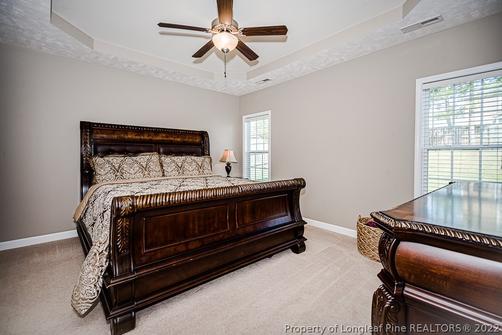 63 Colonist Place Cameron, NC 28326 - Photo 17 of 32 a bedroom with a bed and wooden floor