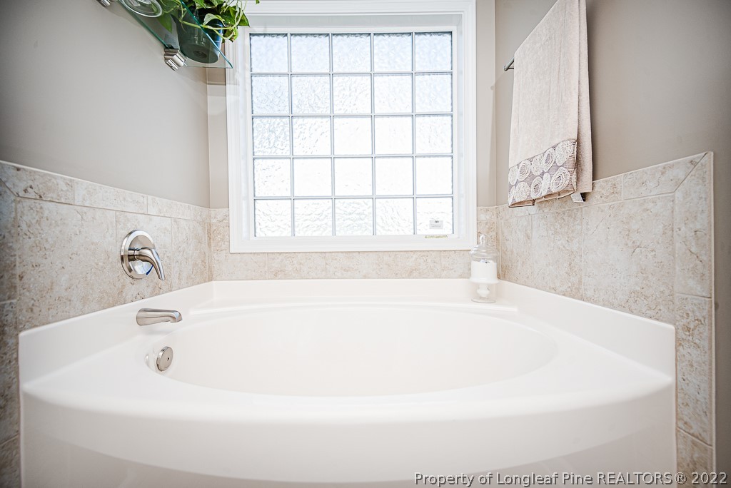63 Colonist Place Cameron, NC 28326 - Photo 20 of 32 a white bath tub sitting in a bathroom next to a window
