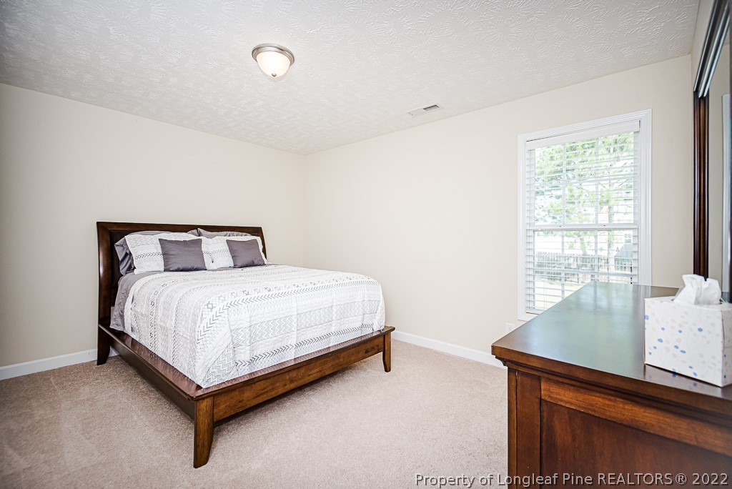 63 Colonist Place Cameron, NC 28326 - Photo 24 of 32 a bedroom with a bed and window