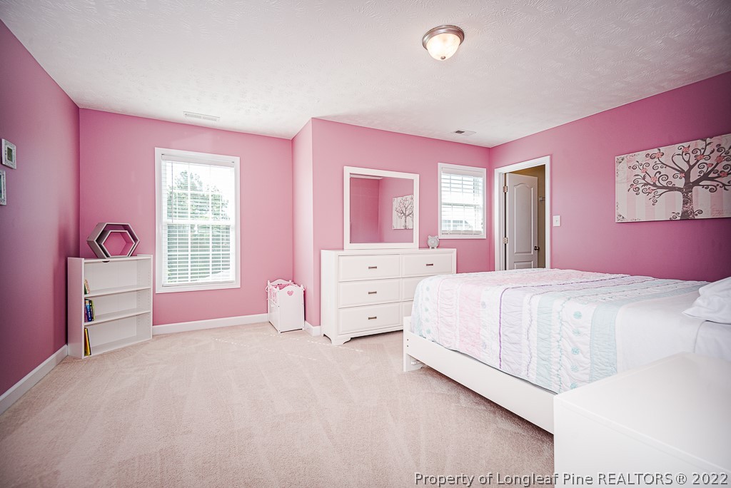 63 Colonist Place Cameron, NC 28326 - Photo 26 of 32 a spacious bedroom with a bed and a dresser
