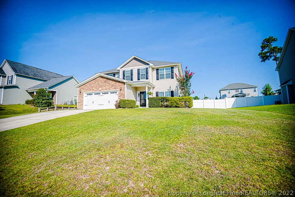 63 Colonist Place Cameron, NC 28326 - Photo 5 of 32 a front view of house with yard and trees in the background