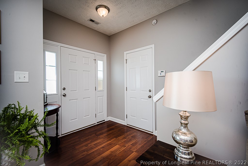 63 Colonist Place Cameron, NC 28326 - Photo 7 of 32 a room with wooden floor and potted plant