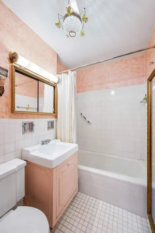 a kitchen with a sink dishwasher and white cabinets