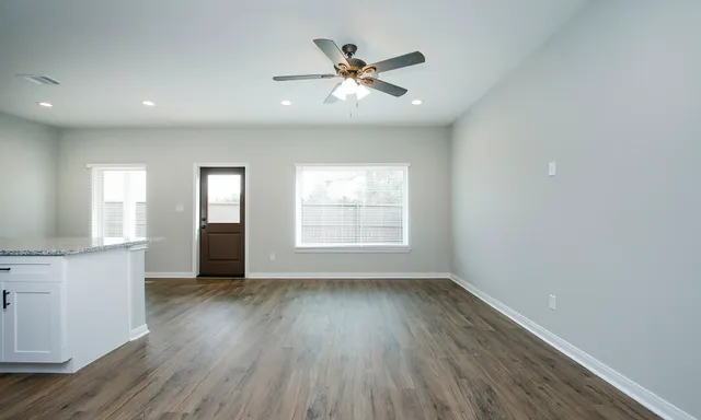 a kitchen with stainless steel appliances granite countertop a refrigerator sink and white cabinets