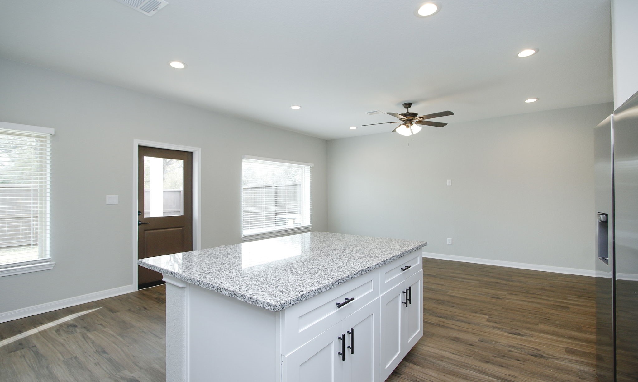 14010 Longstreet Road, Unit 9 Willis, TX 77318 - Photo 22 of 50 a kitchen with a sink chandelier and wooden floor