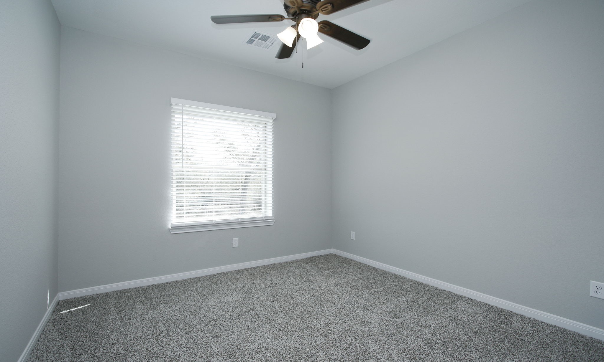 14010 Longstreet Road, Unit 9 Willis, TX 77318 - Photo 26 of 50 an empty room with a window and a fan