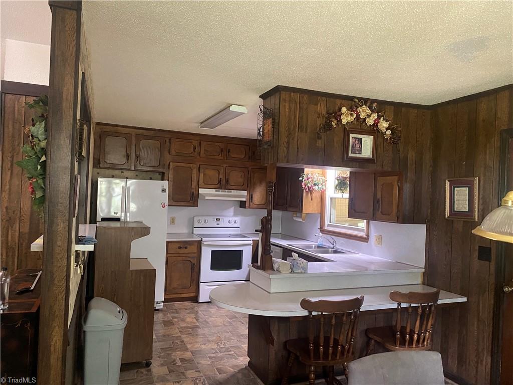1104 Windover Road Randleman, NC 27317 - Photo 12 of 22 view of kitchen ample cabinets and bar area